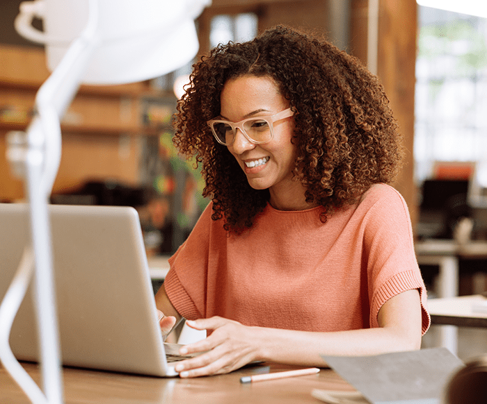 Woman smiling at computer